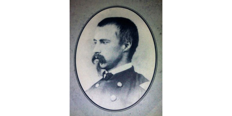 A black and white photo of a man in military uniform.