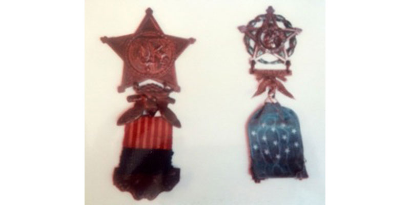 A pair of patriotic ornaments hanging on the wall.