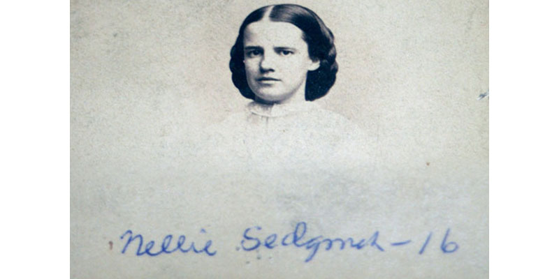 A picture of nellie sedgwick with her signature.