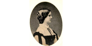 A woman with long hair and a bow in her hair.