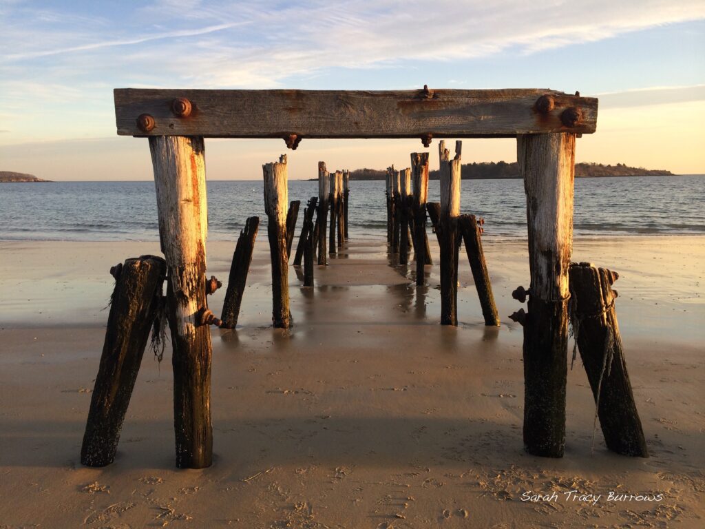 A pier that has been built into the sand.