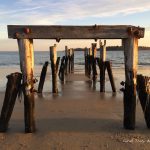 A pier that has been built into the sand.