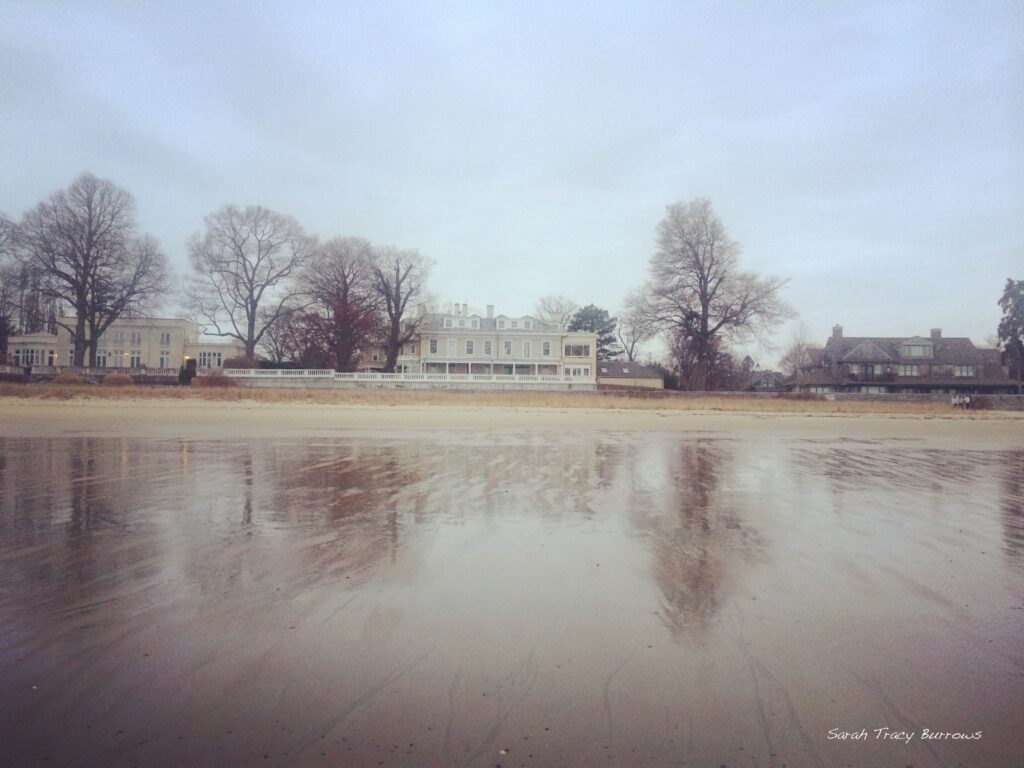 A house on the water with trees in the background