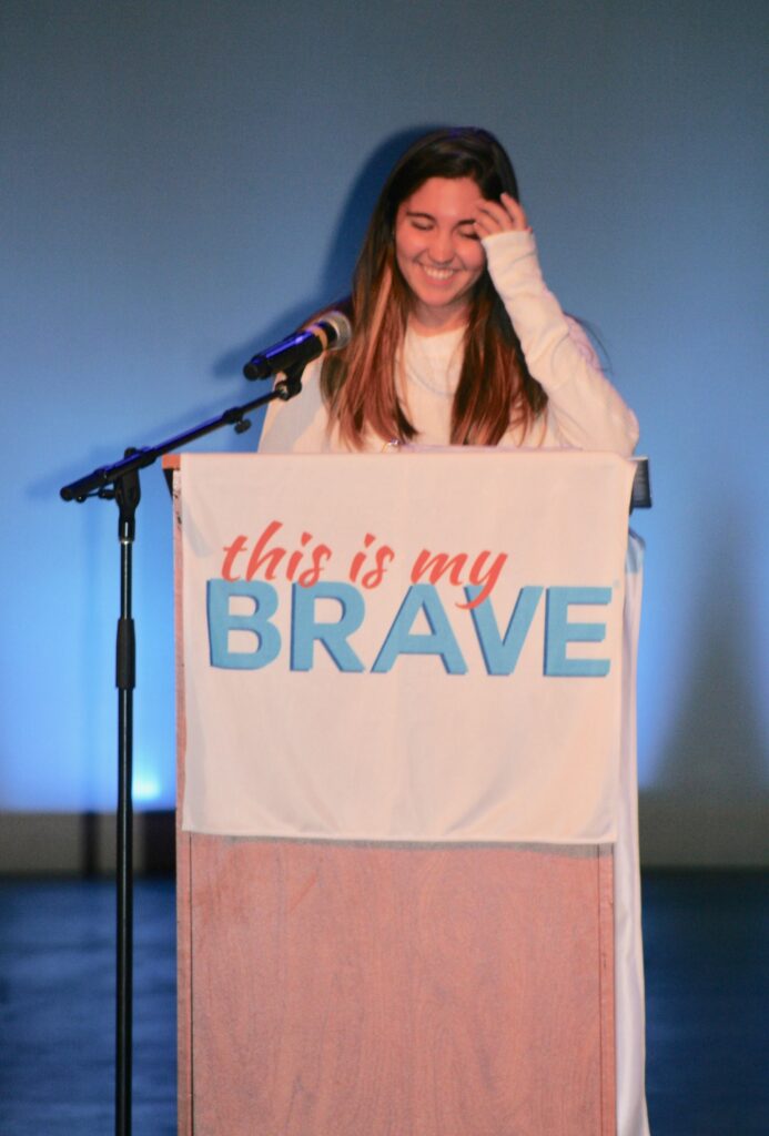 A woman standing at the top of a stage.