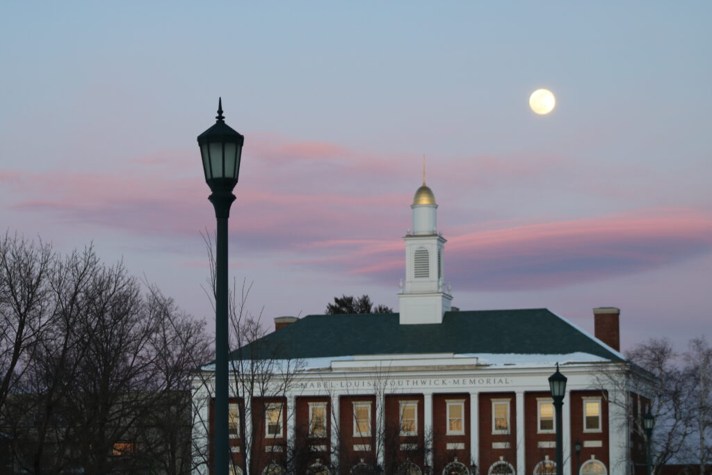 A building with a clock tower and a lamp post