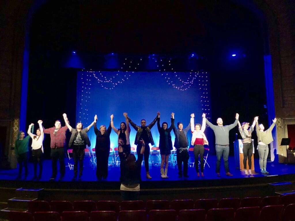 A group of people standing on top of a stage.