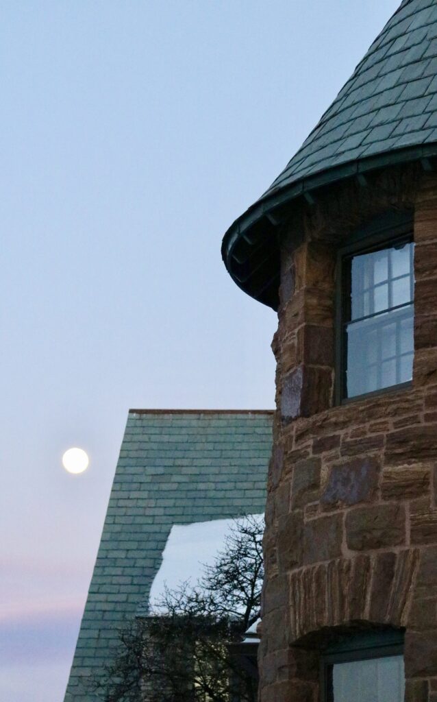 A building with a moon in the background.