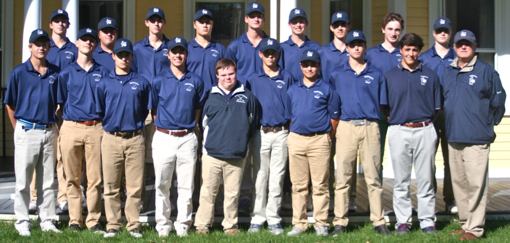 A group of men in blue shirts and tan pants.